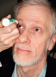 Patient applying eye drops