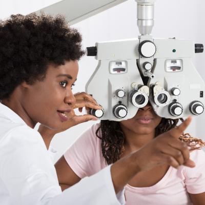 African American woman getting an eye exam.