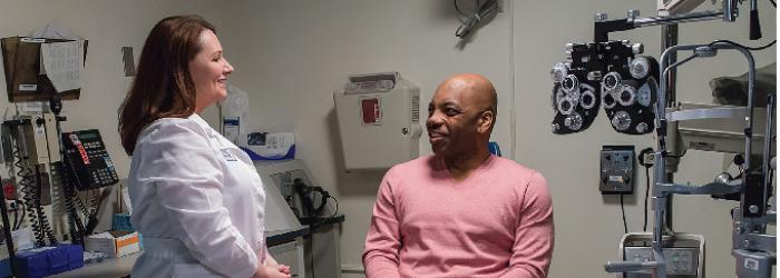 doctor and patient talking at NEI eye clinic