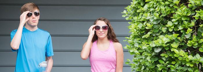 Two people with sunglasses on and workout clothes