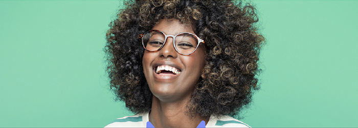 A smiling woman wearing glasses
