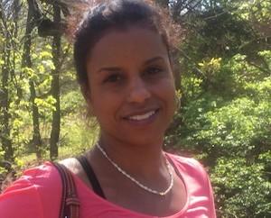 Woman outside in a forest, smiling