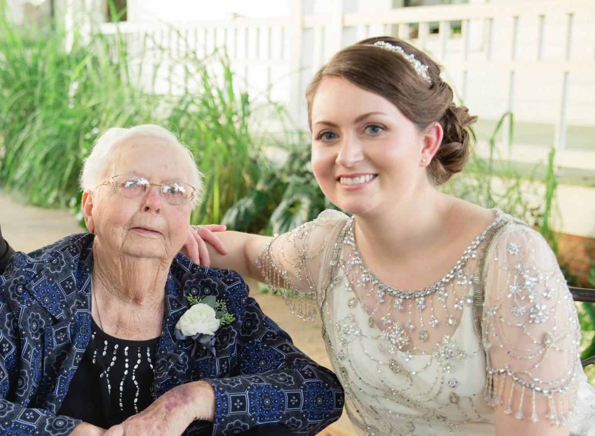 Bride in wedding dress sitting with her grandmother