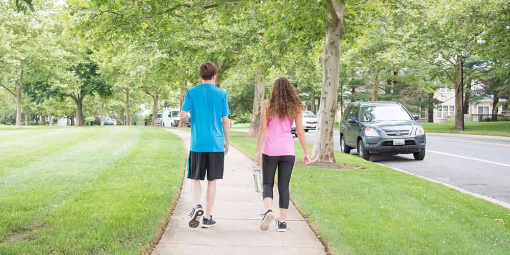 two people are taking a walk outside