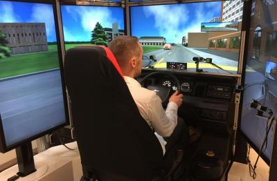 Man at controls with screens surrounding him