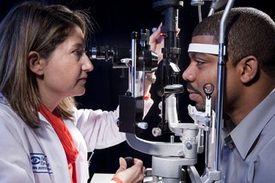 Doctor examines patient's eye using slit lamp