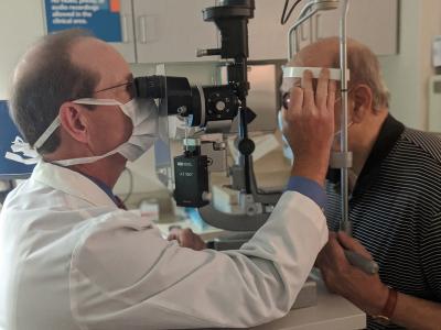 A doctor examines a patient's eye
