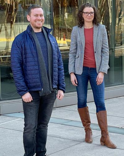 Two scientists standing on a sidewalk