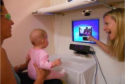 Baby looks at screen, with eye tracker device