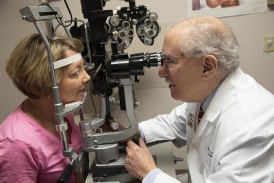 Doctor examines patient's eye