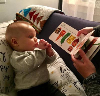 A baby looks at a book