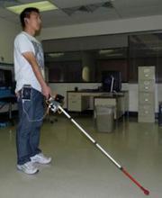 Man using robotic cane in an office