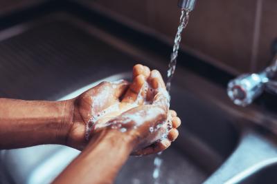 A person washing their hands.
