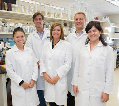 Group of 5 scientists in a laboratory.