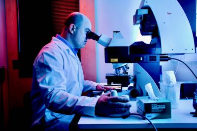Scientist looking in a microscope