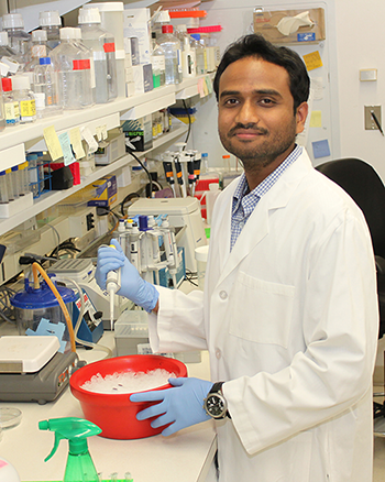 NEI scientist Aman George working in the lab.