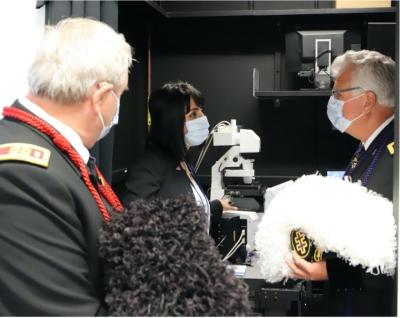 Scientist Mitra Farnoodian Tedrick explains her research project to Commanders of the Knights Templar Eye Foundation
