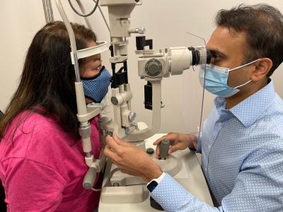 Chirag Jhaveri, MD, examines the eyes of a patient.