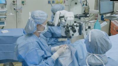 Physician performing surgery in an operating room.