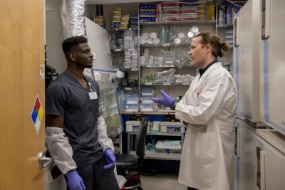 Baranov and colleague talk in the laboratory.