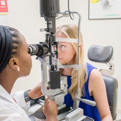 Physician examines patient's eye