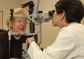 Dr. Emily Chew of the National Eye Institute examines a patient’s eyes. Photo credit: National Eye Institute.