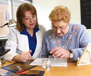 An occupational therapist at Thomas Jefferson University works with a patient who has low vision. Credit: Thomas Jefferson University.