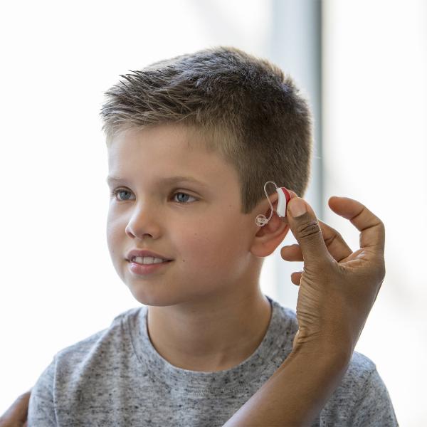 Young boy gets fitted for a hearing aid