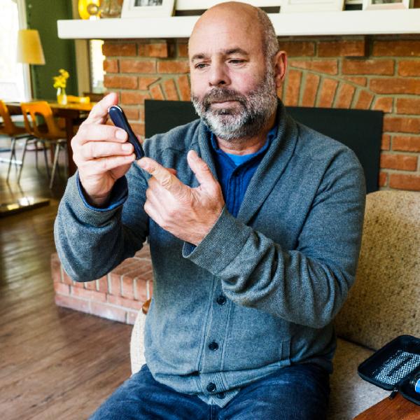 Person with diabetes checks their blood sugar.