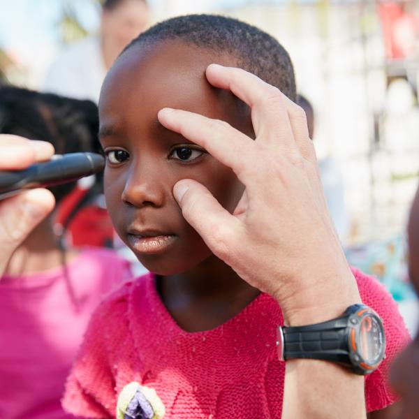 Young boy getting an eye exam.