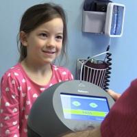 Little girl with the blinq™ device