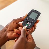 A person with diabetes checks their blood sugar