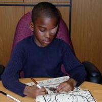 little boy with eye patch simultaneously writing. 