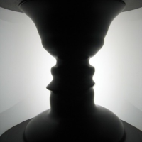 Optical illusion showing a vase or two faces