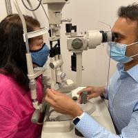 Chirag Jhaveri, MD, examines the eyes of a patient.