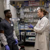 Baranov and colleague talk in the laboratory.