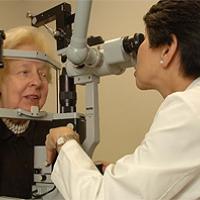 Dr. Emily Chew of the National Eye Institute examines a patient’s eyes. Photo credit: National Eye Institute.