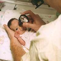 NICU care providers take photos of a premature baby's retinas in the NEI-funded e-ROP study of telemedicine for retinopathy of prematurity. Photo credit: Children's Hospital of Philadelphia 