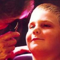 Young boy gets eye exam. 